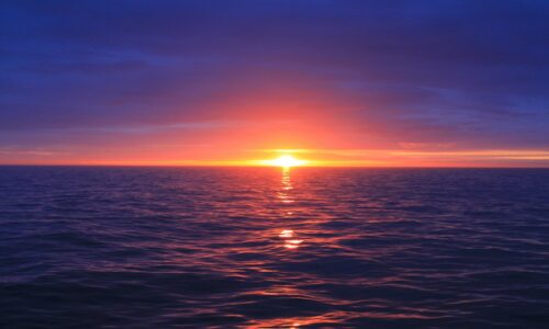 body of water during sunset
