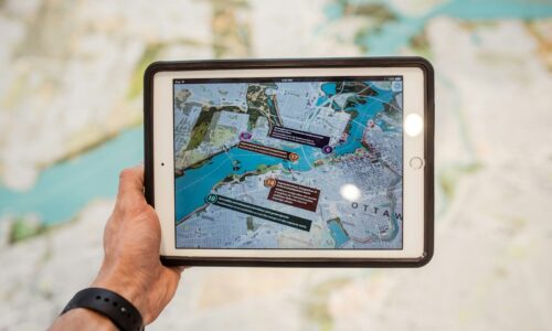 person holding white ipad with black case