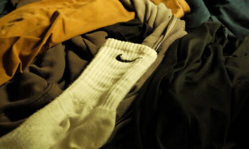 a pile of clothes sitting on top of a bed