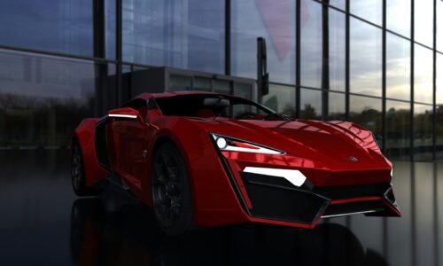 a red sports car parked in front of a building