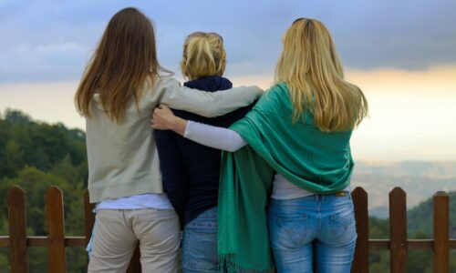 a group of three women standing next to each other