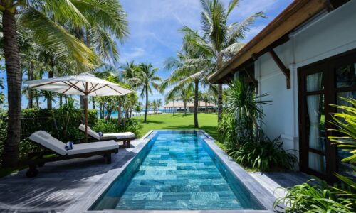 white and brown wooden house near swimming pool during daytime