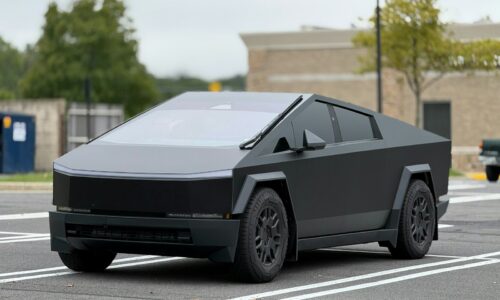 A futuristic car is parked in a parking lot