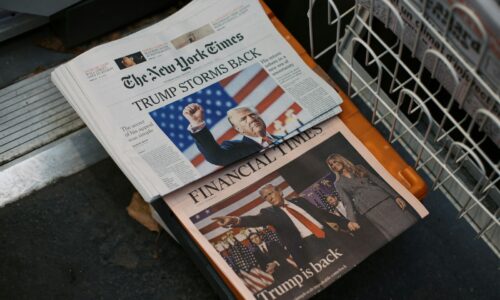 A newspaper sitting on top of a metal dishwasher