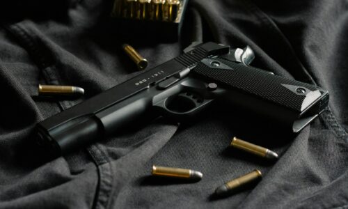 black semi automatic pistol on black textile