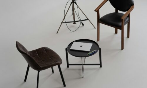 three chairs and a table with a laptop on it