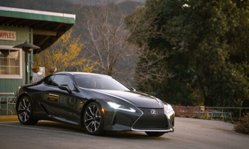 gray Lexus coupe parked in front of building