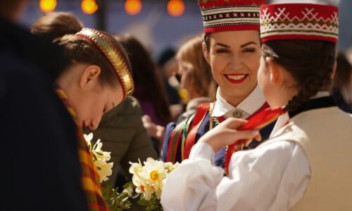 a couple of girls wearing red and white hats and smiling