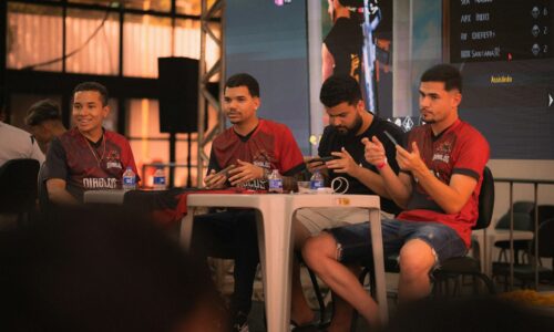 Four men sitting at a table during an event.
