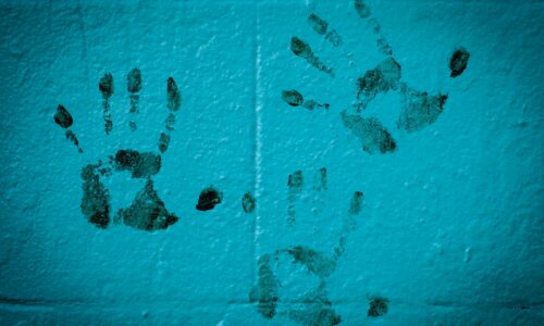 three hand prints on white wall