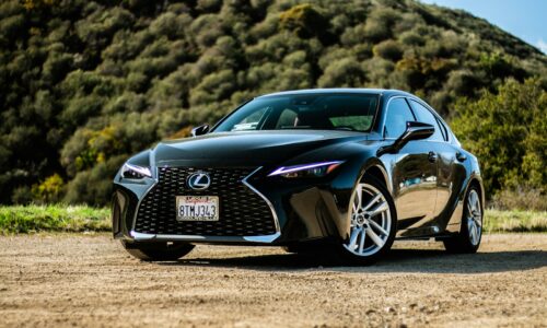 black porsche 911 on brown field during daytime