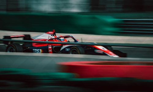 a man driving a race car on a track