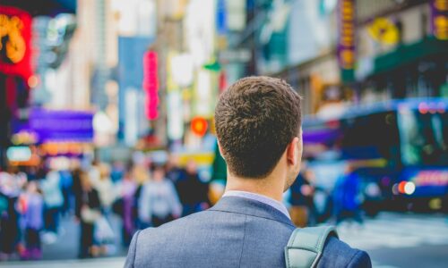 shallow focus photography of man in suit jacket's back