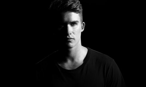 grayscale photography of man wearing shirt