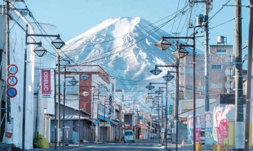 a city street with a mountain in the background